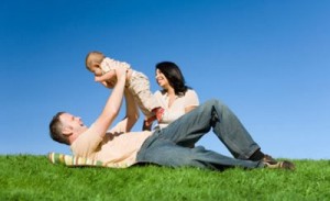 A man and woman are sitting on the grass.